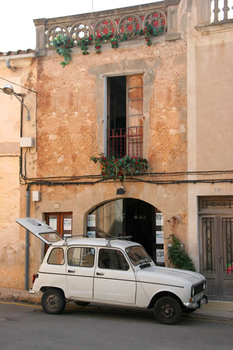 Old car and residential building on the isle of mallorca photo